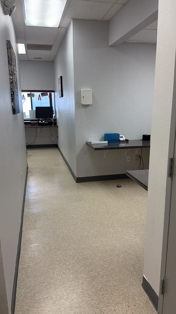 Finished flooring running through the corridor to the reception window of a medical office in El Paso after a Sage Intelligence tenant improvement.