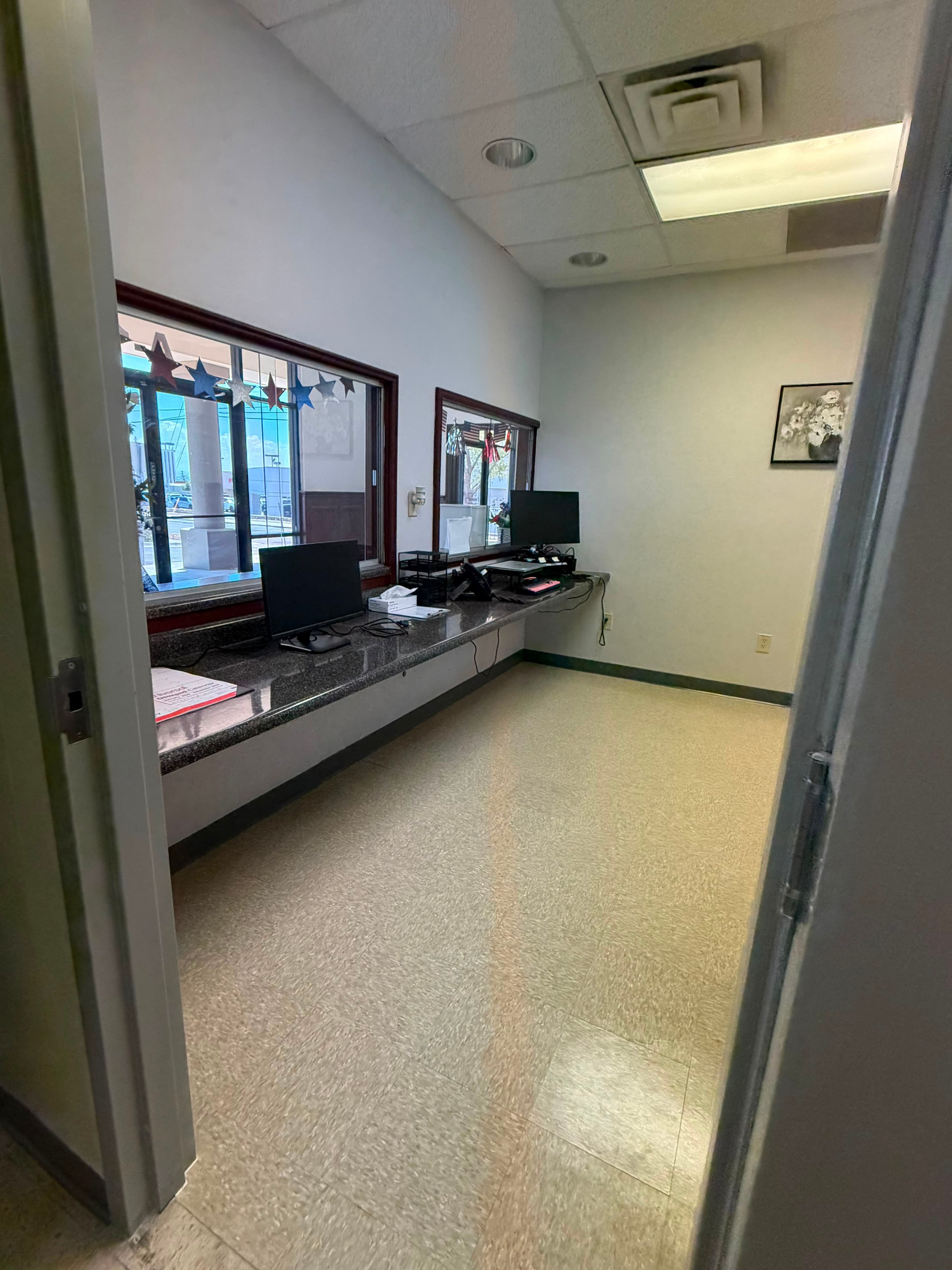 Completed front office and reception area with new flooring installed, workstations and equipment returned to service.